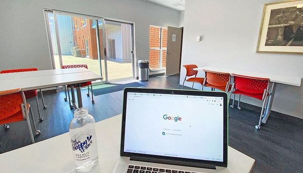 a laptop computer sitting on top of a table