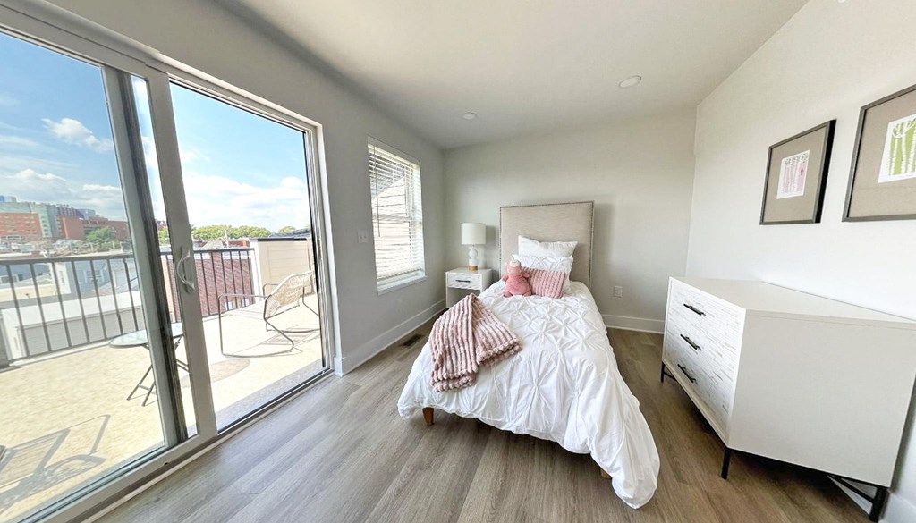 a bedroom with a bed and a large window