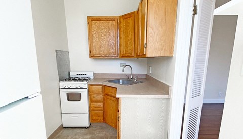 a small kitchen with a stove and a sink