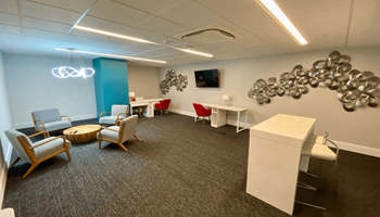 a meeting room with chairs and a table and a wall with a cluster of spheres at The Washington at Chatham, Pittsburgh, PA 15219