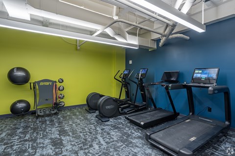 A gym with a treadmill, exercise bike, and other equipment.at The Jones Tower at the Collective, Pittsburgh, PA 15203