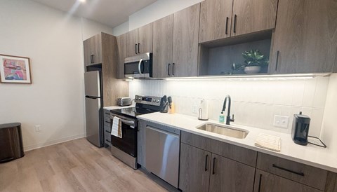 A kitchen with wooden cabinets and stainless steel appliances.