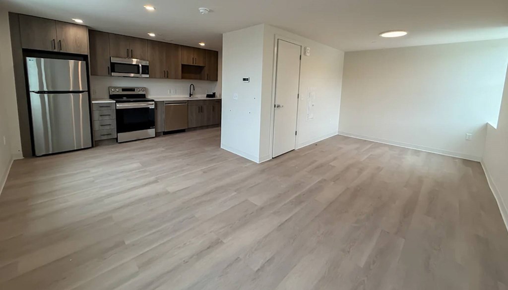 A kitchen with a refrigerator, oven, and microwave.at The Jones Tower at the Collective, Pittsburgh Pennsylvania