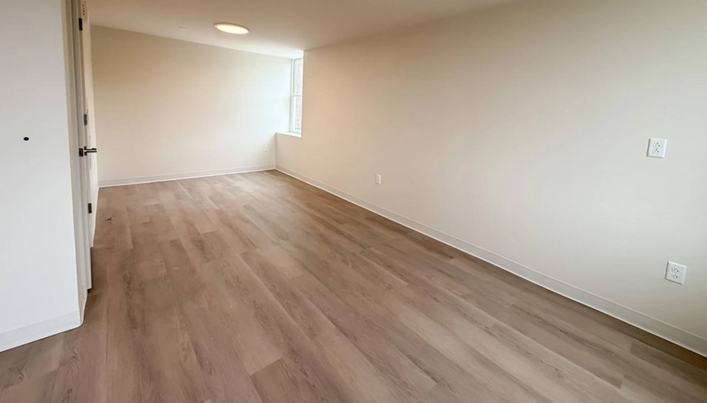 A room with light wood flooring and a white door.at The Jones Tower at the Collective, Pennsylvania