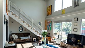 a view of the living room with the stairs leading up to the second floor - Photo Gallery 2