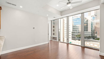 a bedroom with hardwood floors and white walls at The Washington at Chatham, Pittsburgh