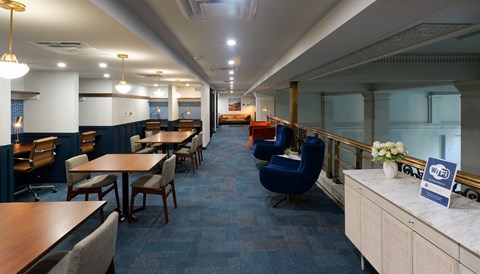 Co-working Mezzanine a dining room with tables and chairs and a counter at The Commonwealth Building, Pittsburgh, 15222