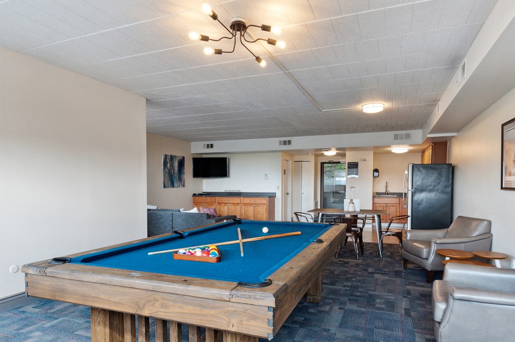 a living room with a pool table and a television
