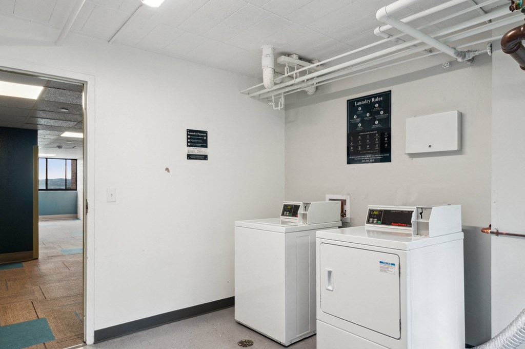 a laundry room with two washing machines and a washer and dryer