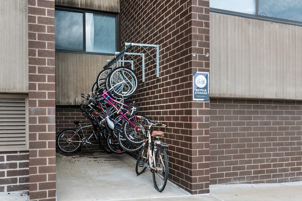A bunch of bicycles are parked on a bike rack at Walnut Towers at Frick Park, Pittsburgh, PA 15217
