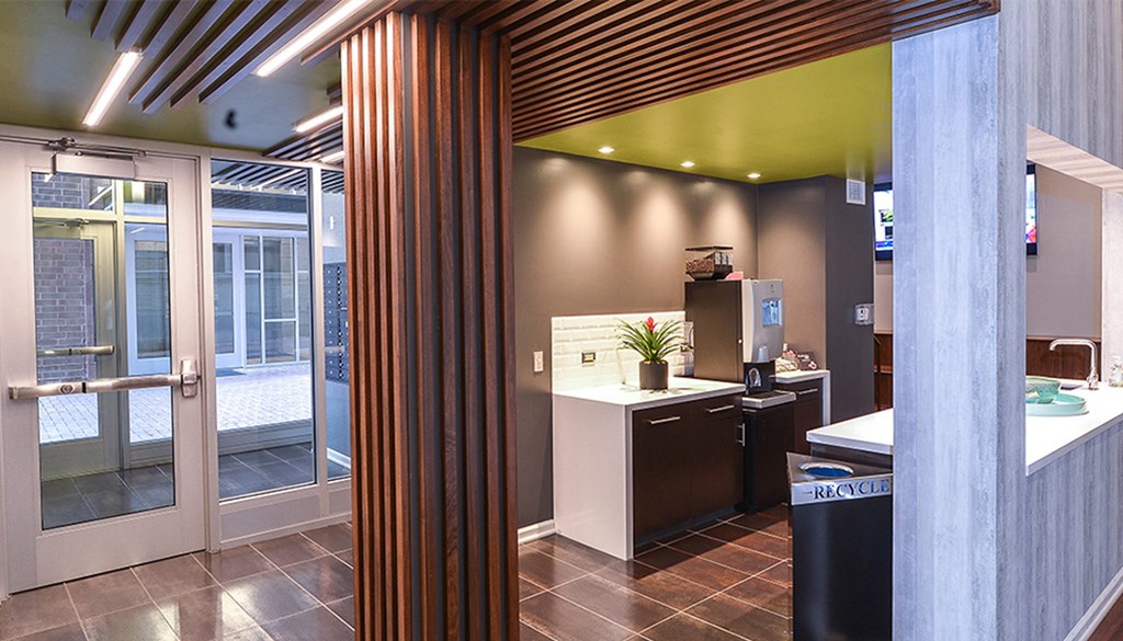a view from the kitchen into the reception area with a wood column in the foreground at Walnut on Highland, Pittsburgh, PA