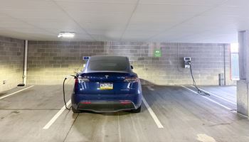 a car is plugged into a battery charger in a parking garage Hot Metal Flats apartments, Southside Pittsburgh, PA