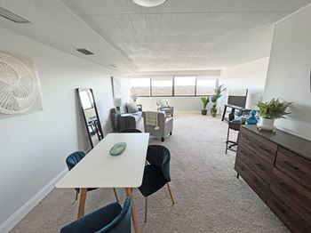 an open living room and dining room with a white table and chairs at Walnut Towers at Frick Park, Pittsburgh