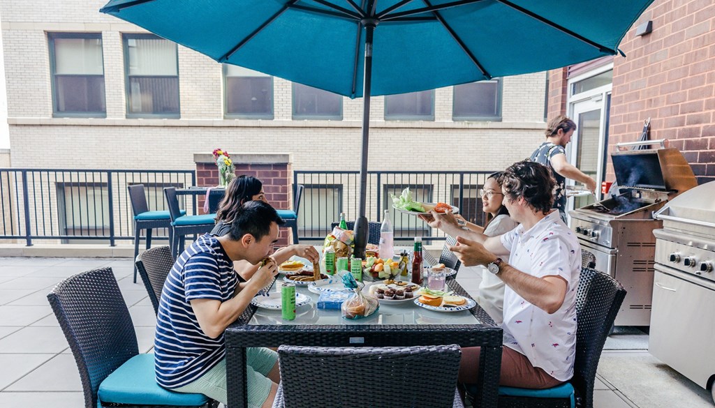 a group of people sitting around a table eating food at Walnut on Highland, Pittsburgh, PA