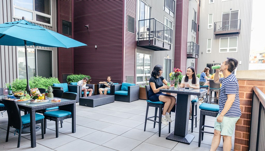 a group of people sitting at a table on a patio at Walnut on Highland, Pittsburgh, PA
