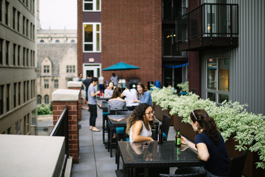 people sitting at tables on a patio in front of a brick building at Walnut on Highland, Pittsburgh, PA
