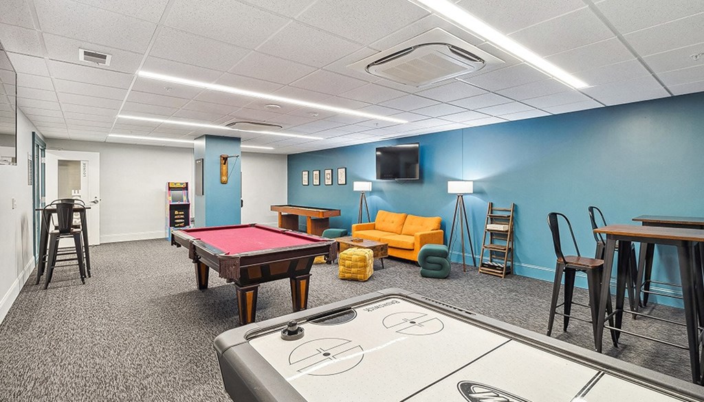 A room with a pool table, couch, and television. at The Washington at Chatham, Pennsylvania, 15219
