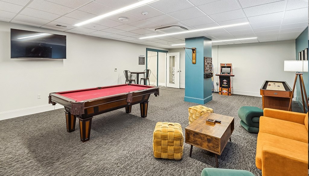 A room with a pool table A room with a pool table, chairs, and a television. at The Washington at Chatham, Pennsylvania, 15219