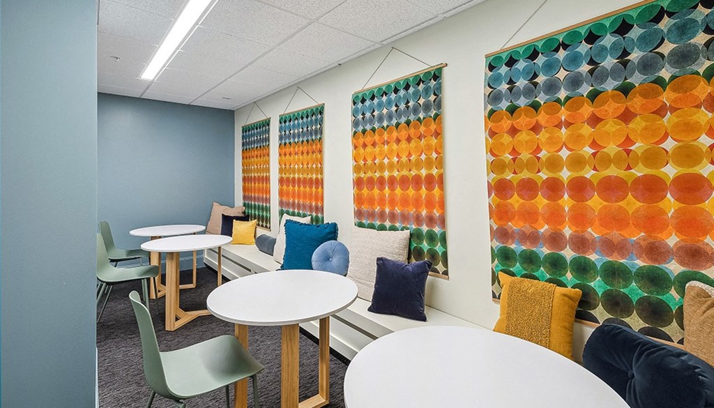 A room with tables and chairs and a wall of circles. at The Washington at Chatham, Pennsylvania, 15219