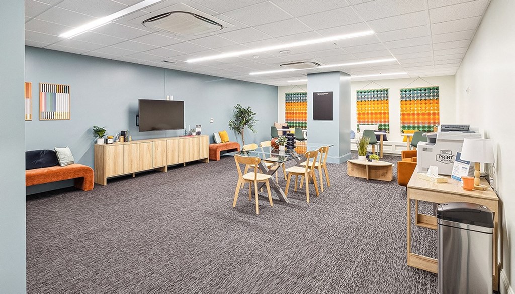 A room with a grey carpet and wooden furniture. at The Washington at Chatham, Pennsylvania, 15219