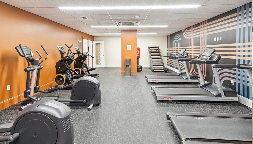 A gym with treadmills, elliptical machines, and stationary bikes. at The Washington at Chatham, Pennsylvania, 15219