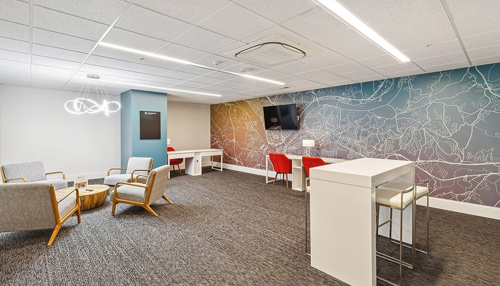 A conference room with a TV, chairs, and a table. at The Washington at Chatham, Pennsylvania, 15219