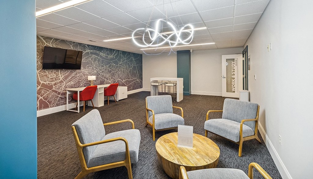 A conference room with a TV, chairs, and a table. at The Washington at Chatham, Pennsylvania, 15219