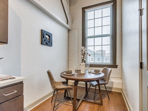 A dining room with a table set for two.