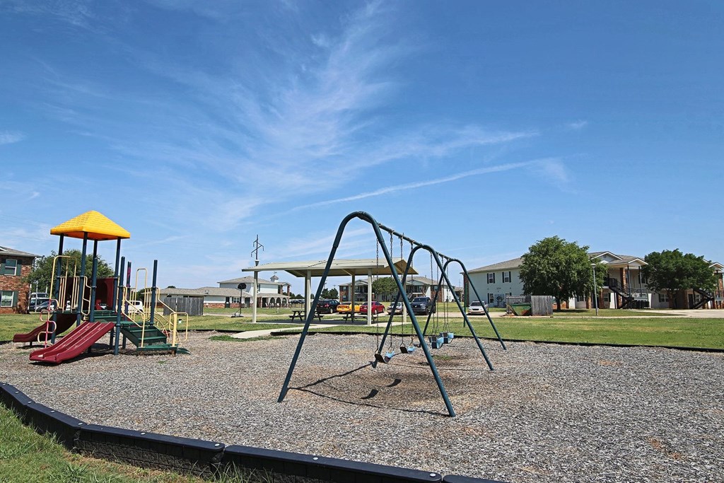 a swing set at a playground in a park