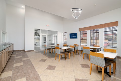 a dining room with tables and chairs and a counter
