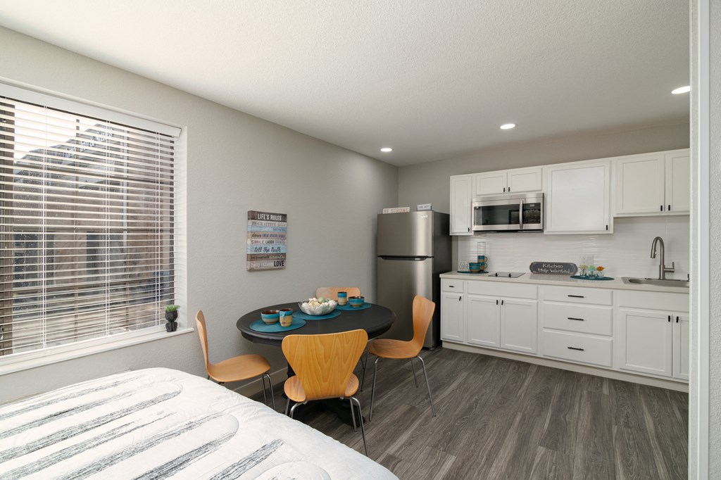 a kitchen and dining room with a table and chairs