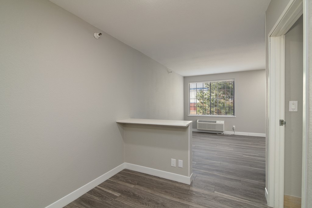 an empty room with a desk and a window