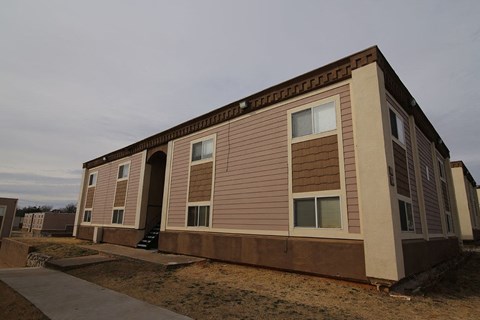 a small building with shuttered windows on the side of it