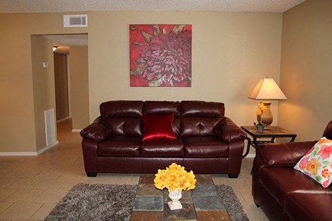 a living room with leather furniture and a painting