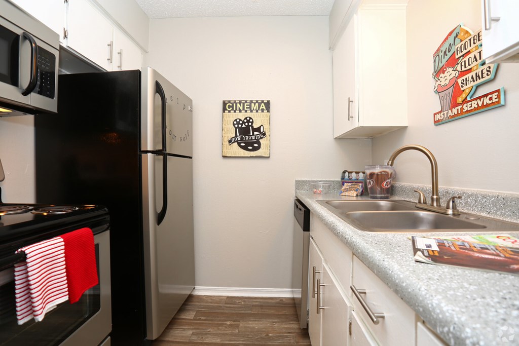A kitchen with a sign that says "CINEMA" on the wall.