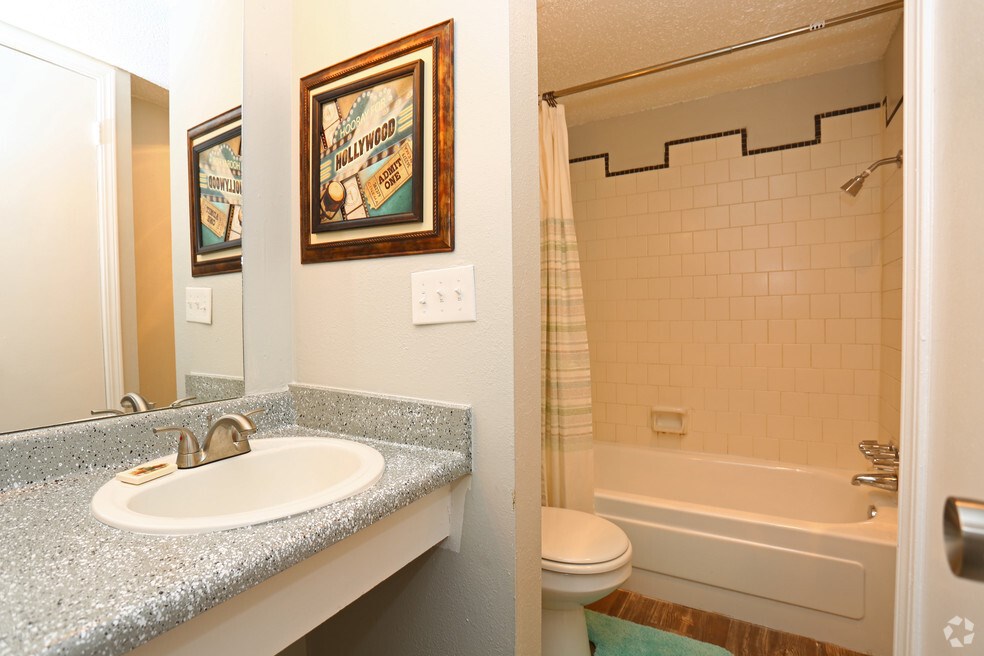 A bathroom with a sink, toilet and bathtub.