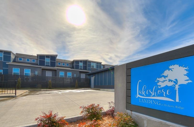A building with a sign that says Lakshore Landing Stickney Ridge.