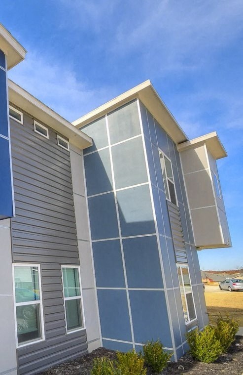 A modern house with a blue and grey exterior.
