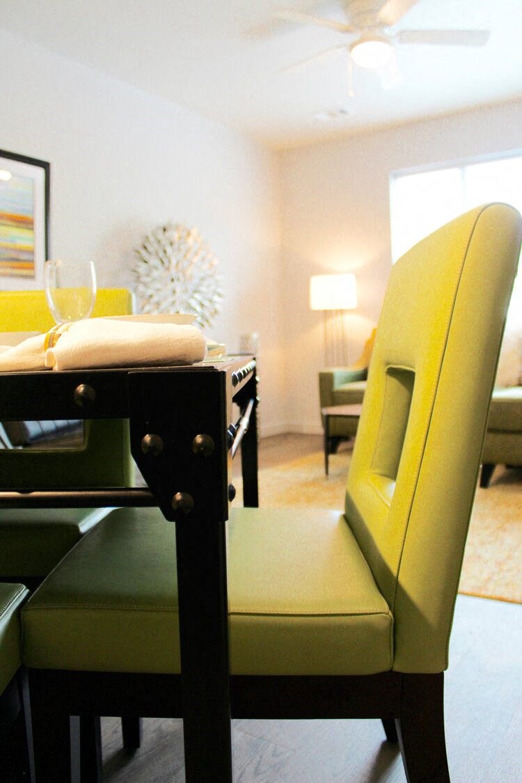 a yellow chair at a table in a living room