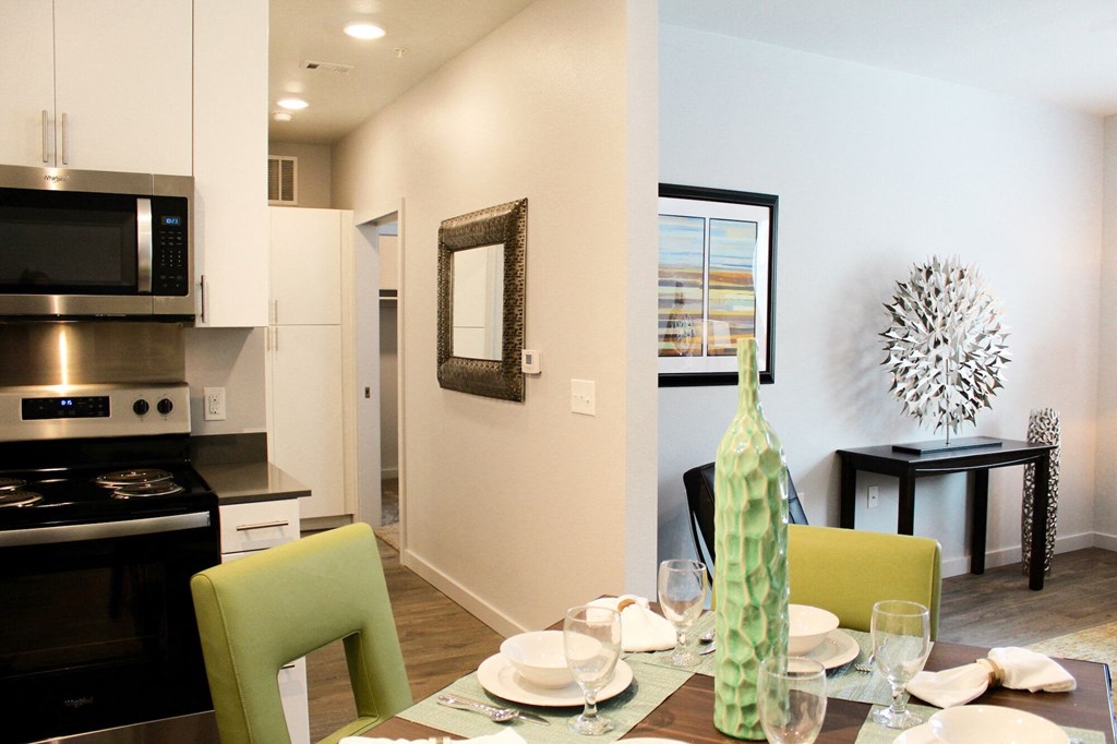 a kitchen and dining room with a table and chairs