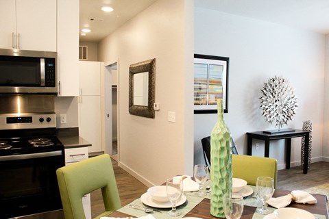 a kitchen and dining room with a table and chairs