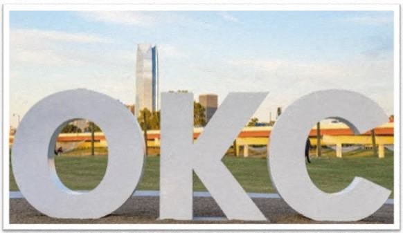 a view of the sign with a city in the background