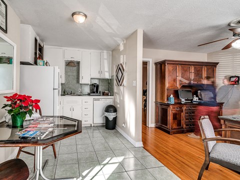 a kitchen and dining room with a table and chairs