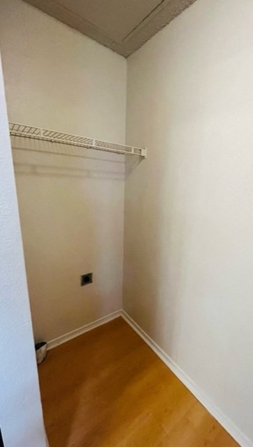 an empty room with a white wall and a white shelf