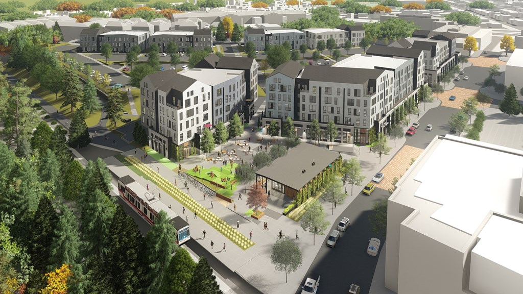 an aerial view of a city street with buildings and trees
