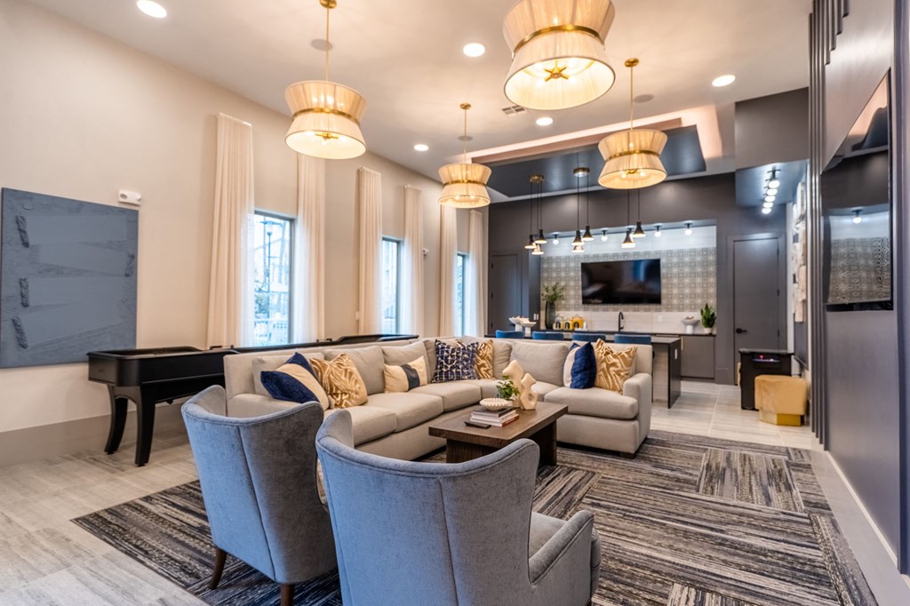 a living room with couches and chairs and a piano