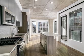 a kitchen with stainless steel appliances and wood floors