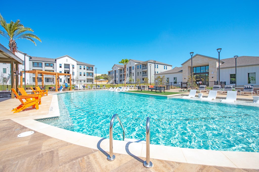 a swimming pool with apartments in the background