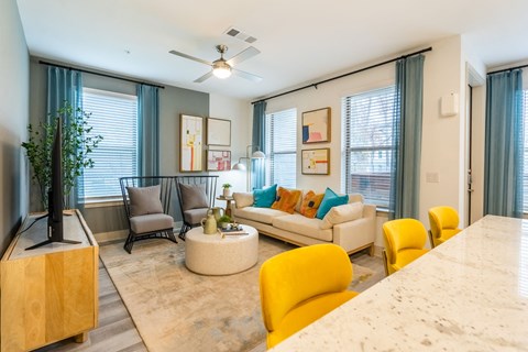 a living room with couches and chairs and a table