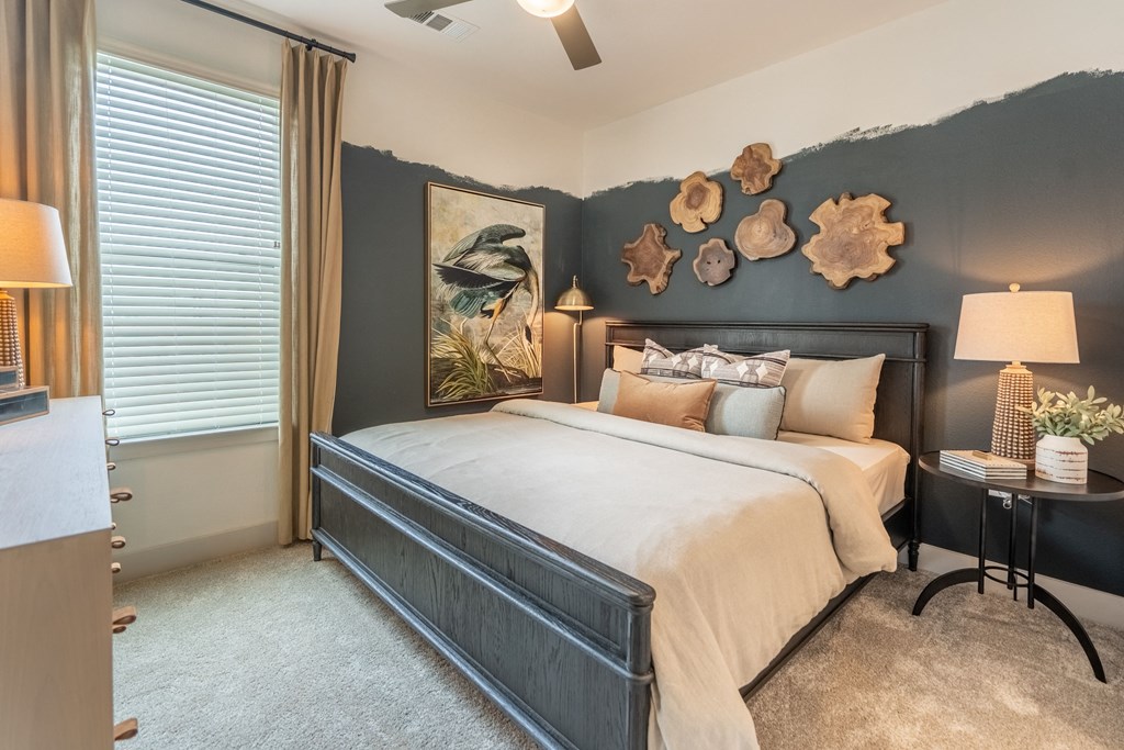 a bedroom with a large bed in front of a window